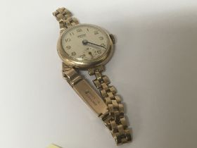 A 9carat gold ladies watch with attached 9carat go