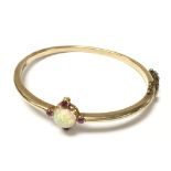 A 9ct gold cabochon Opal & ruby bangle, approximat
