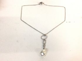 A modern design silver necklace with attached Roco