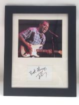 A framed and glazed signed photo of Robert Cray, a