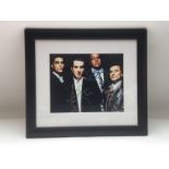 A framed and glazed signed photo of the four main