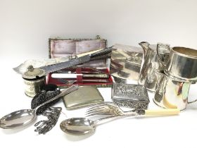 A collection of silver plate items including knive
