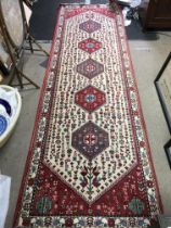 A Red and Beige hand woven rug with pheasant, floral, and patterned decoration. Dimensions