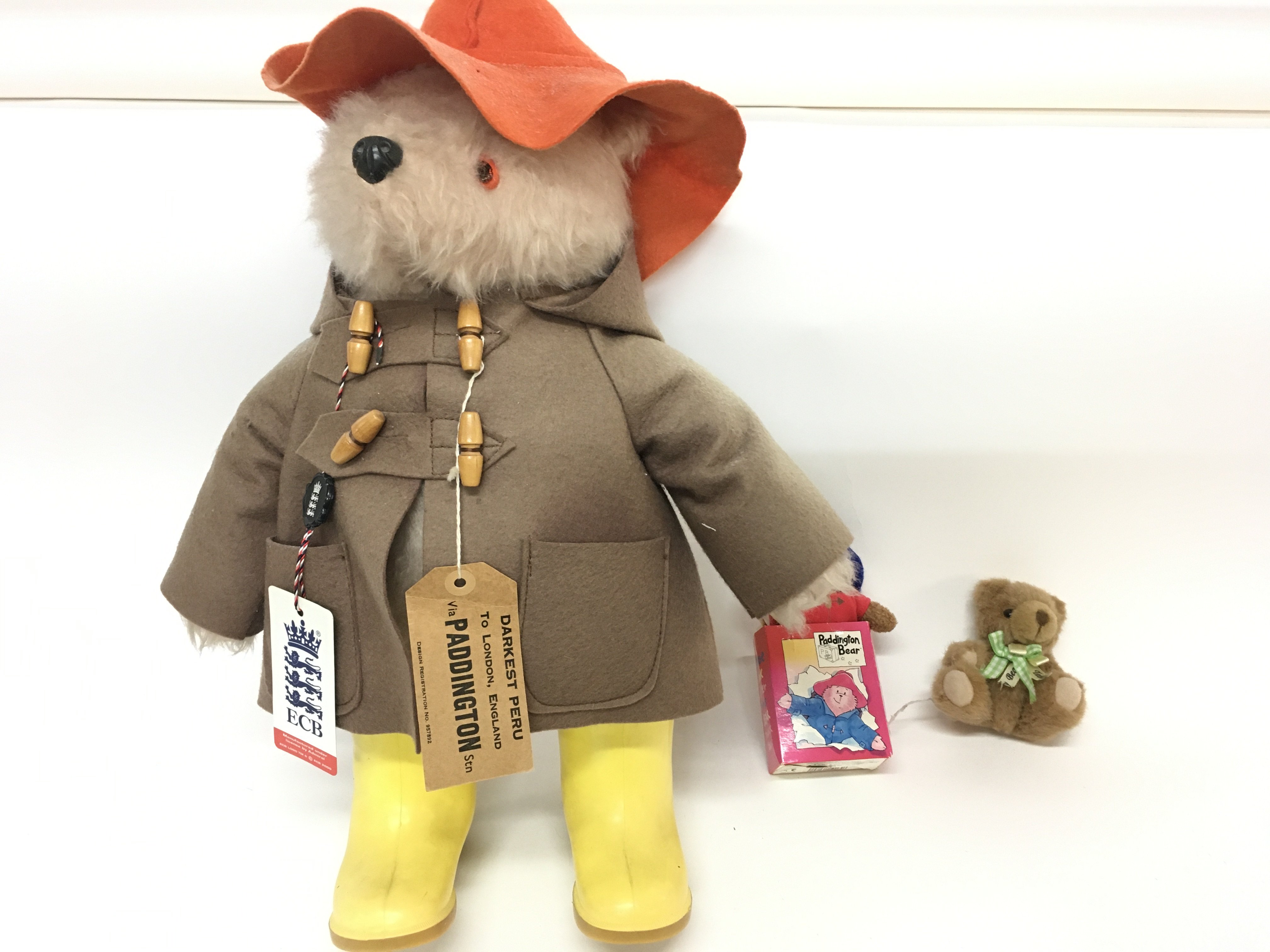 A vintage Paddington bear with yellow boots and tw