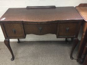 An oak side table fitted with three drawers. On ca