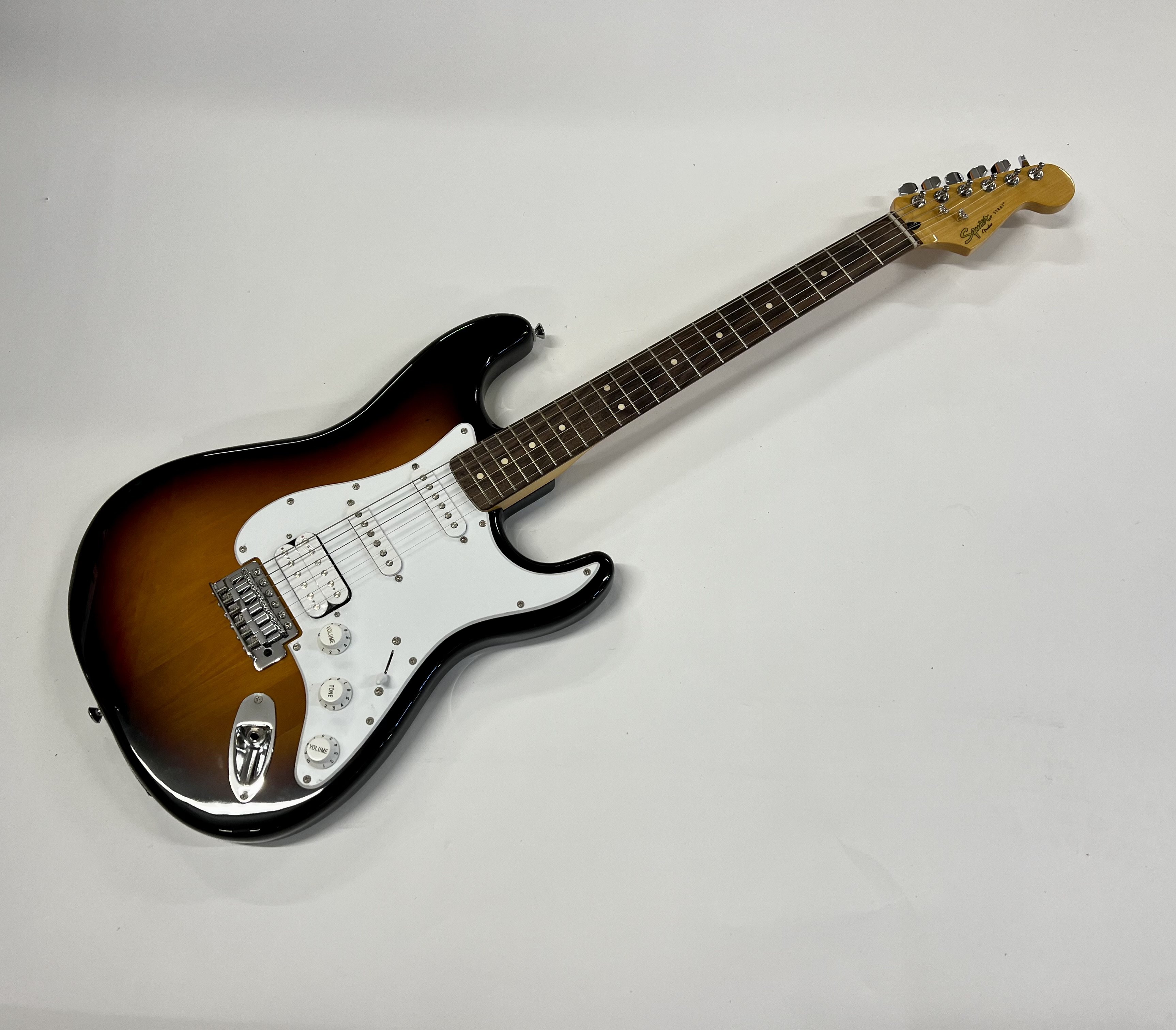 A Squier Stratocaster guitar in Fender Tweed Case