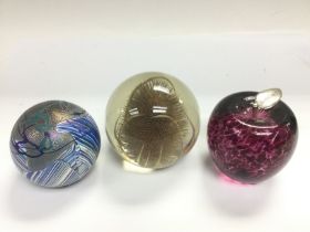 Three glass paperweights including an Isle of Wigh