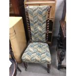 A Victorian walnut prayer chair with a high back a