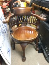 A mahogany swivel action office chair. Shipping ca