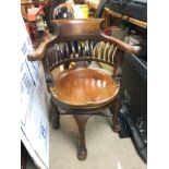 A mahogany swivel action office chair. Shipping ca