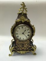 A boulle style mantle clock with a Roman numeral d