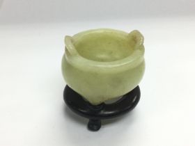 A small jade pot on a carved hardwood stand, total
