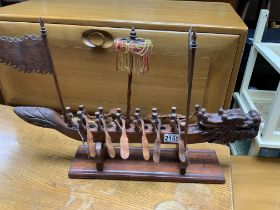 An Indonesian carved wooden drum boat. (D)