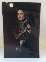 A signed photo of Michael Jackson with COA. Approx