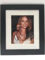 A framed and glazed signed photo of Mariah Carey,