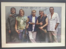 A framed and glazed Deep Purple poster signed by t