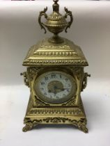 A Victorian brass mantle clock with Arabic numeral
