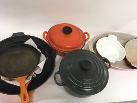 A collection of assorted Le Creuest pots and pans.