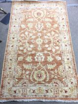 An orange floral decorated rug, dimensions 54x92cm postage catD