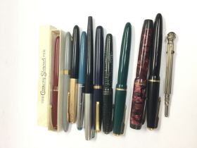 A collection of fountain pens and a propelling pen