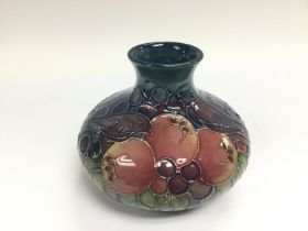 A Moorcroft onion vase depicting birds and fruit o