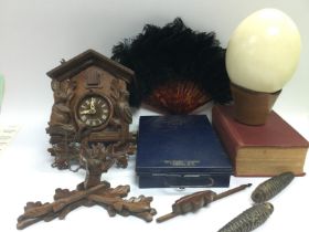 A collection of items comprising a carved cuckoo c