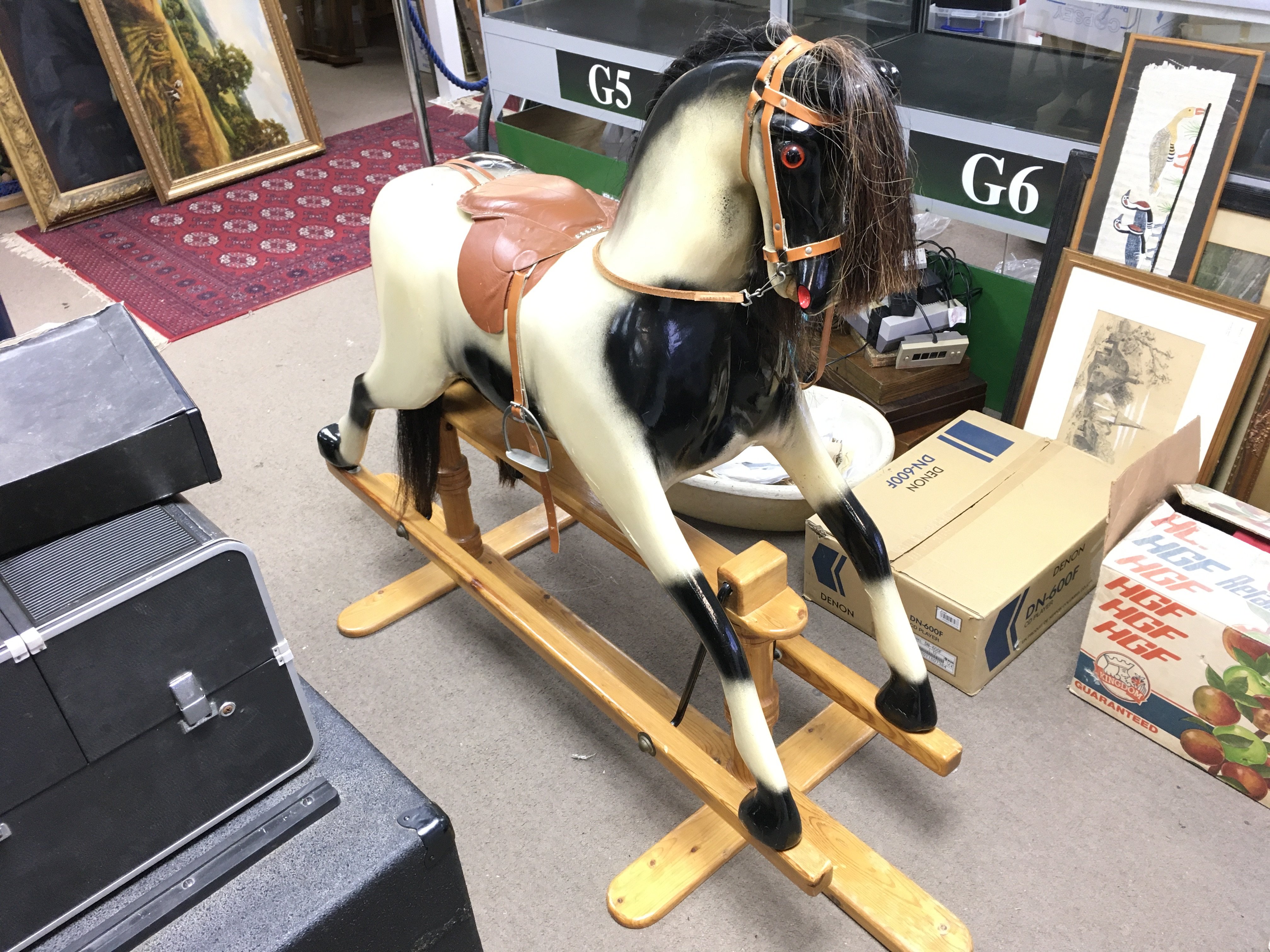 A vintage rocking horse, with leather saddle and h