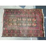 A small brown and red rug , dimensions 115x84cm.