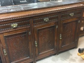 An Edwardian walnut sideboard fitted with three dr