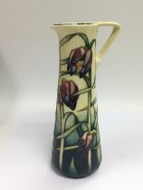 A Moorcroft jug with polychrome floral deceation o