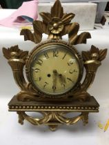 A wooden gilt wall clock.