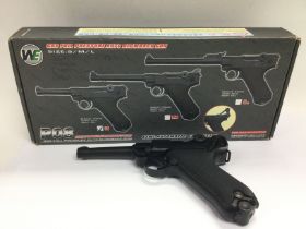 A boxed WE semi automatic airsoft pistol. Shipping