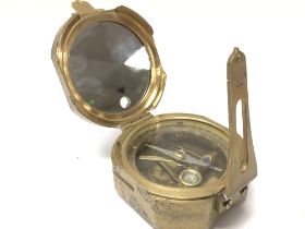 A brass cased compass, postage category B