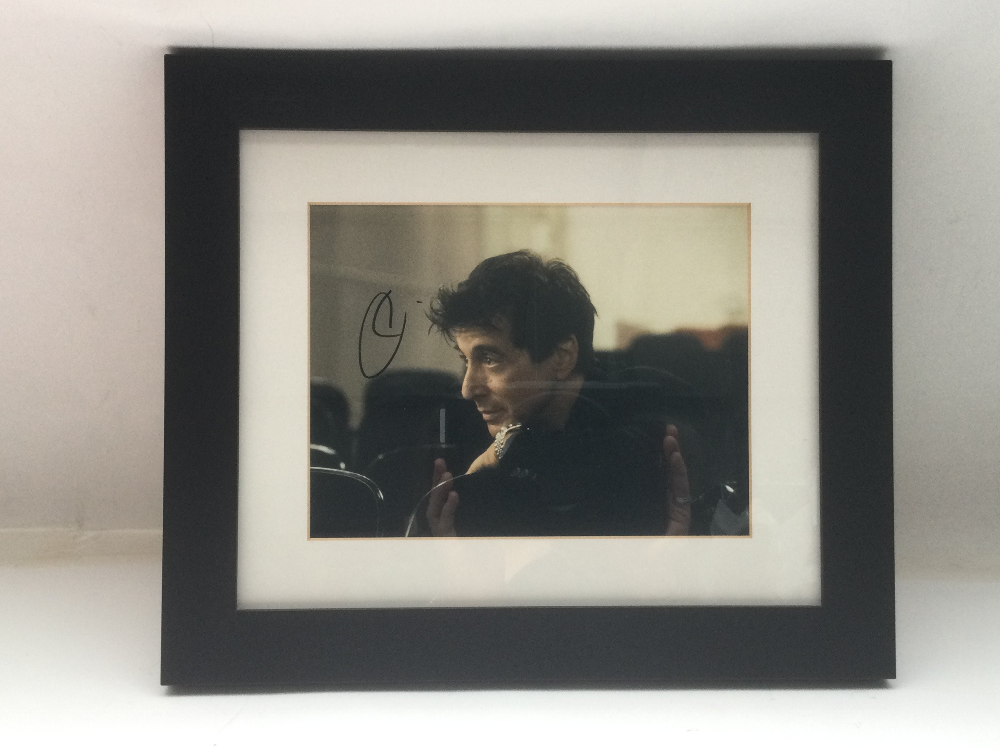 A framed and glazed signed photo of Al Pacino, app