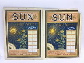Two Victorian Sun fire insurance calendars each with a painting of rural views to the reverse,