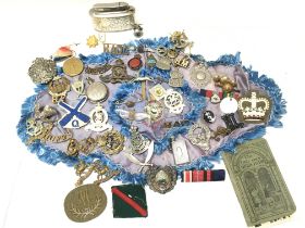 A Collection of assorted military badges, medals a
