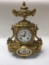 A gilt metal classic style mantle clock with a Rom