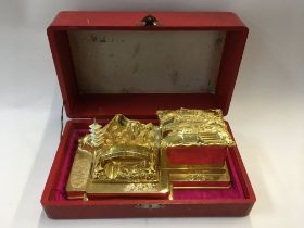 A cased Japanese gilt metal desk stand music box,