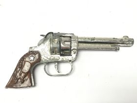 A vintage Toy revolver, lone star cap gun