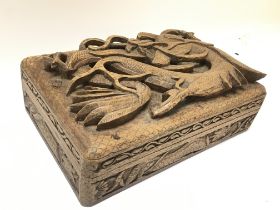 An oriental carved box with dragon decoration , 15