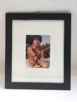 A framed and glazed signed photo of Jackie Chan, a