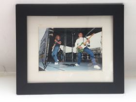 A framed and glazed signed photo of Francis Rossi