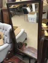 A Victorian mahogany cheval mirror with scrolled s