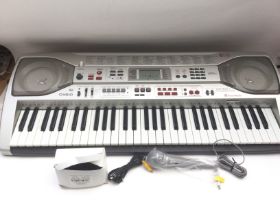 A boxed Casio LK93 TV keyboard with accessories an