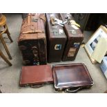 A collection of leather and other old suitcases. P
