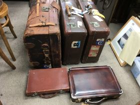 A collection of leather and other old suitcases. P