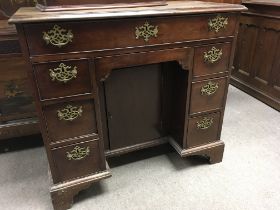 A Georgian mahogany knee hole desk the regular top