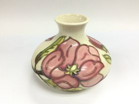 A Moorcroft onion vase decorated with pink flowers