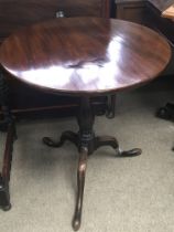 A George III mahogany tip action table with a circ