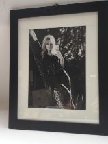 A framed and glazed signed photo of Kylie Minogue,